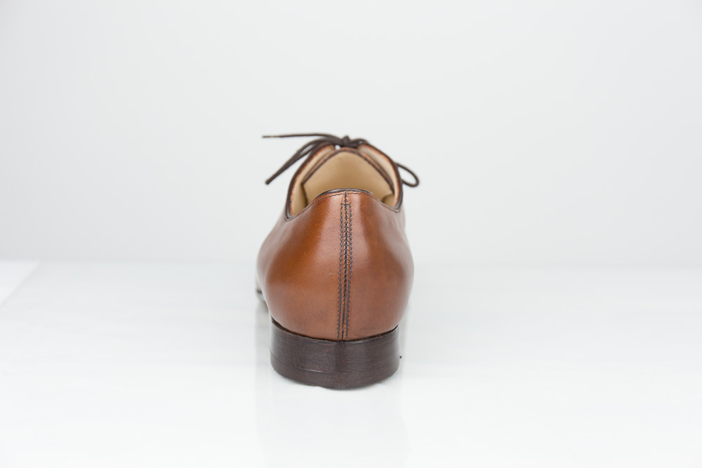 One piece bespoke men shoe cognac-coloured leather rear view